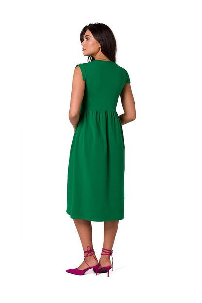 Back view of a sophisticated green midi dress by BeWear, highlighting its elevated waistline and graceful silhouette.