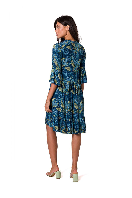 Sophisticated back view of a romantic mismatched daydress by BeWear, featuring a blue dress adorned with leafy prints and a feminine ruffle detail.
