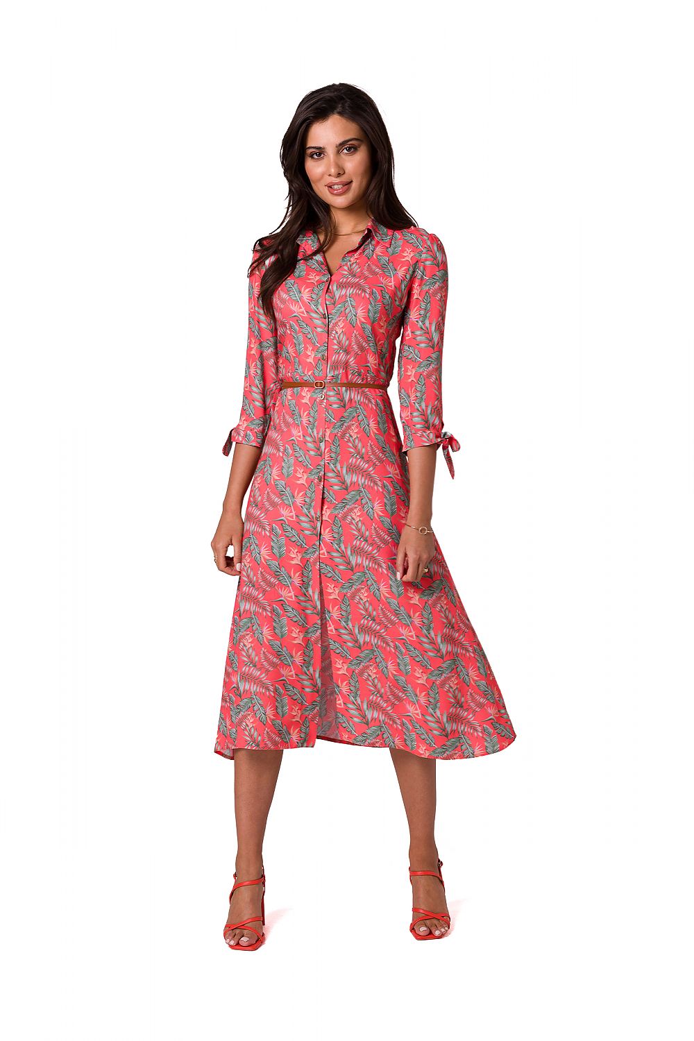 Stunning A-line daydress in coral with a tropical leaf design, featuring a collar and belted waist, styled by BeWear. Model exudes sophistication in this chic garment.