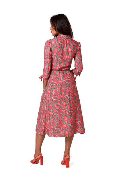 Back view of an elegant coral A-line daydress with a tropical print, by BeWear, showcasing a sophisticated collar and belted design for a luxurious finish.