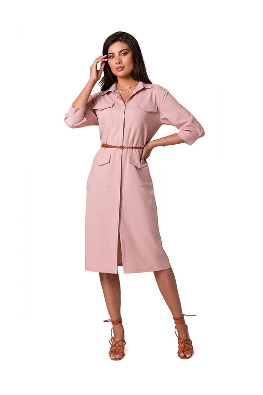 Elegant woman modeling a luxurious BeWear safari dress with belt, features a flattering collar and dual front pockets, showcasing a chic casual style.
