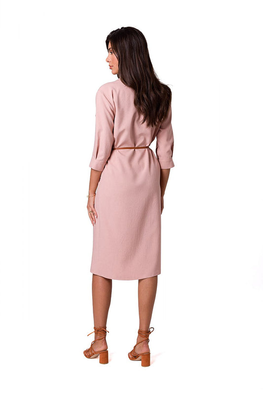 Back view of a sophisticated woman in a luxurious BeWear safari dress, showcasing a flattering fit and stylish belted waist.