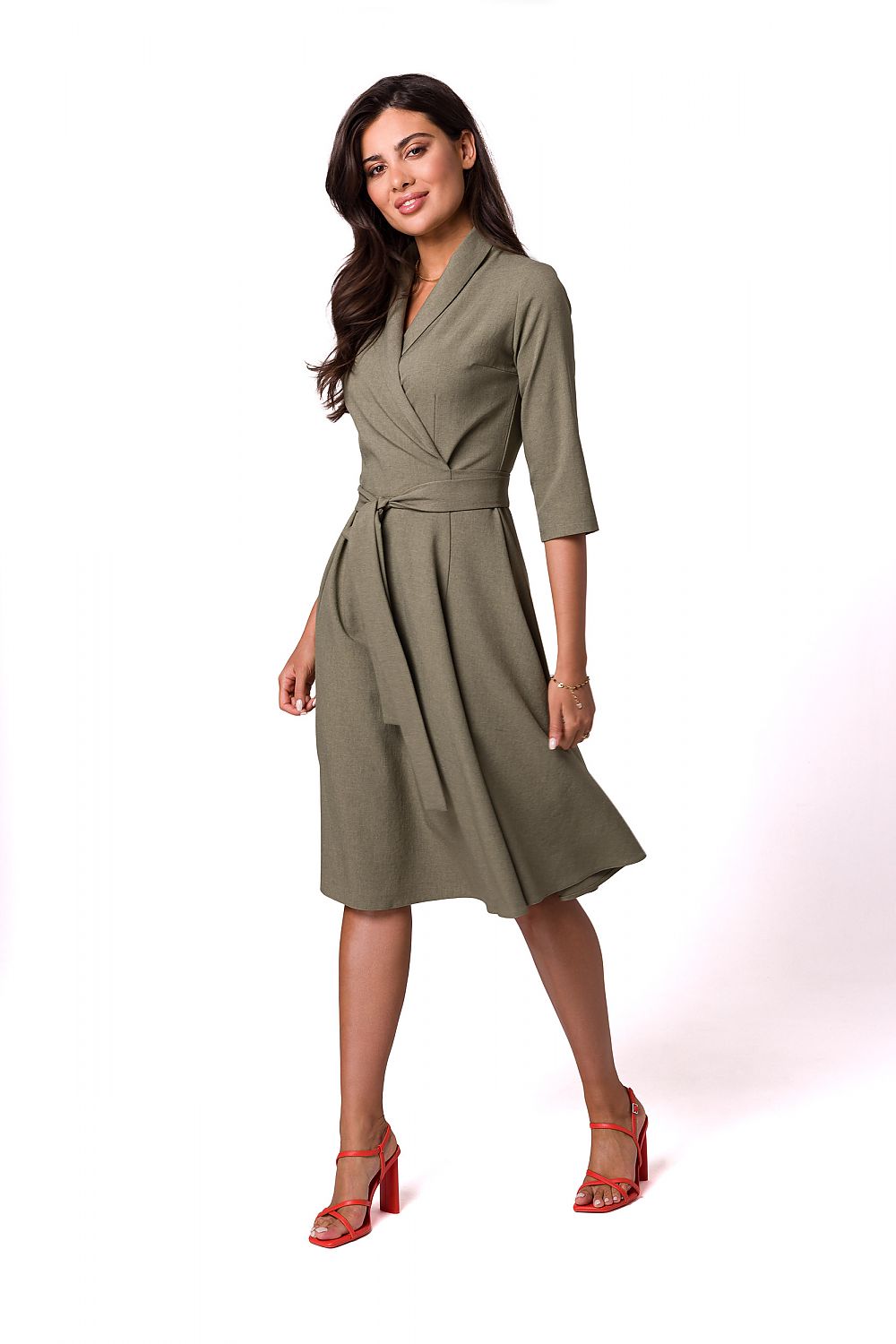 Chic feminine flared daydress in olive green, featuring a shawl collar and waist tie, elegantly styled by BeWear on a model, ideal for a sophisticated look.