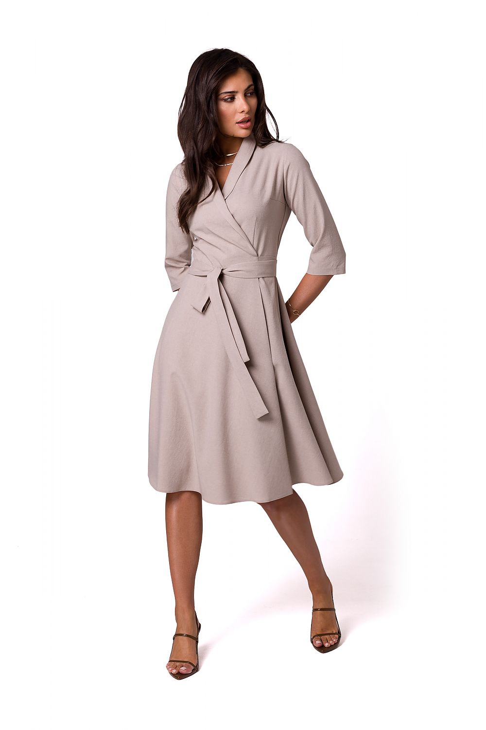 Elegant polyester daydress with shawl collar and waist tie by BeWear, featuring a feminine flared silhouette, model elegantly posing in a soft beige colour.