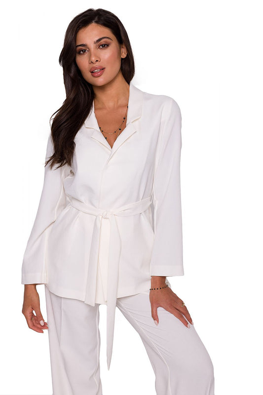 Elegant woman wearing a lightweight unbuttoned BeWear summer jacket with a belt, showcasing a luxurious white fabric and a stylish design, perfect for summer outings.