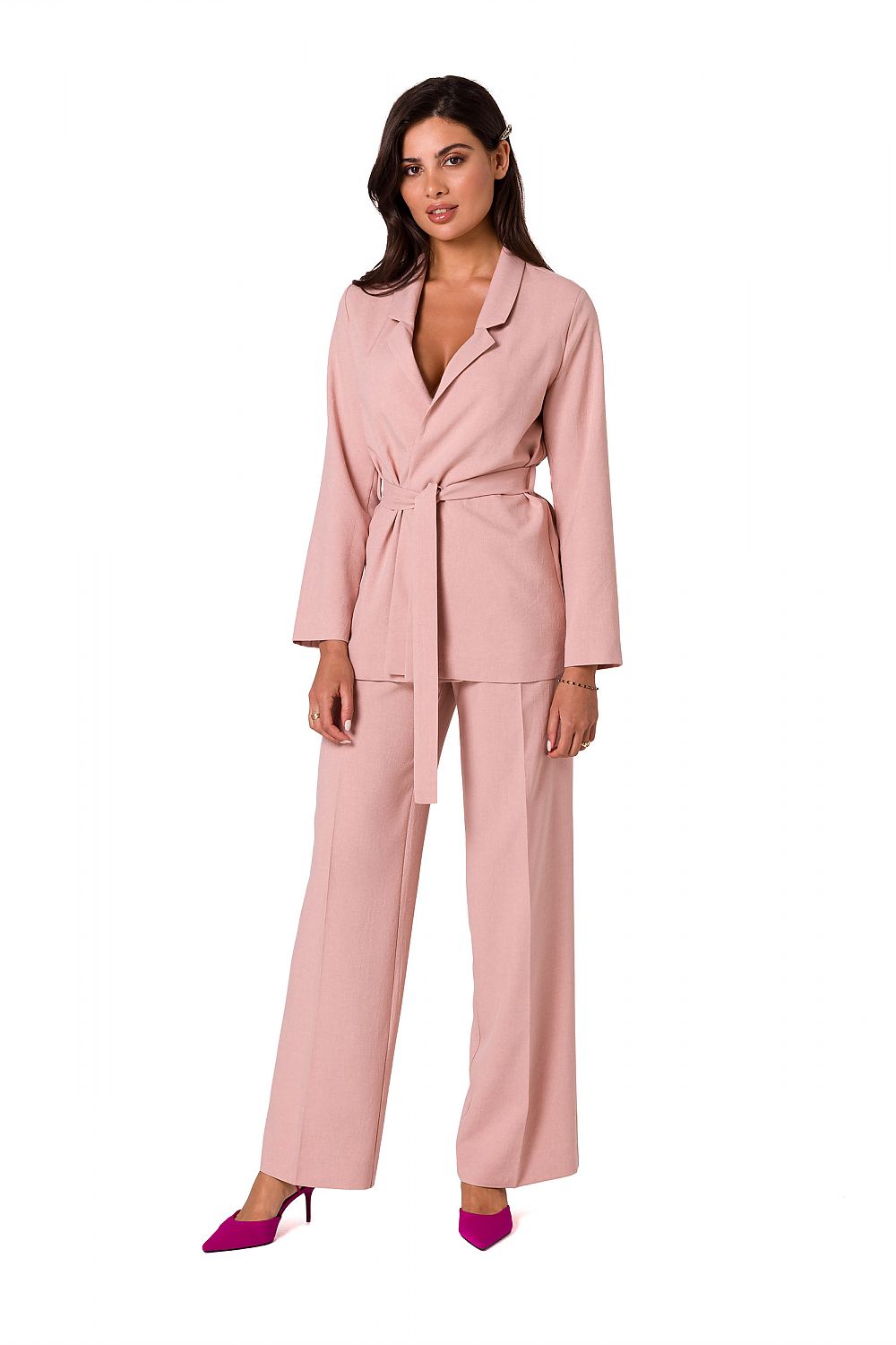 Full body view of a fashionable woman in a pink unbuttoned summer jacket with a belt from BeWear, styled elegantly with matching trousers and heels.