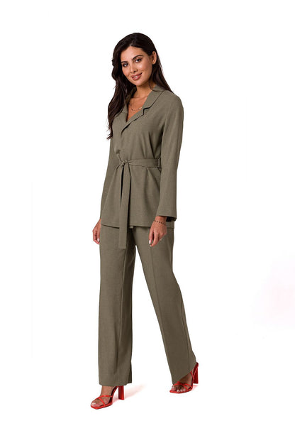 Elegant model showcasing a lightweight unbuttoned BeWear summer jacket with belt in olive green, paired with matching trousers, embodying a sophisticated summer style.