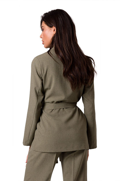 Rear view of a model in a lightweight BeWear summer jacket in olive green, highlighting the luxurious fabric and stylish belt design.
