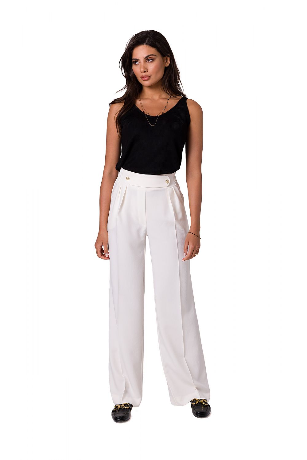 Model showcasing elegant lightweight trousers with decorative gold buttons by BeWear, styled with a black tank top, perfect for a chic capsule closet.