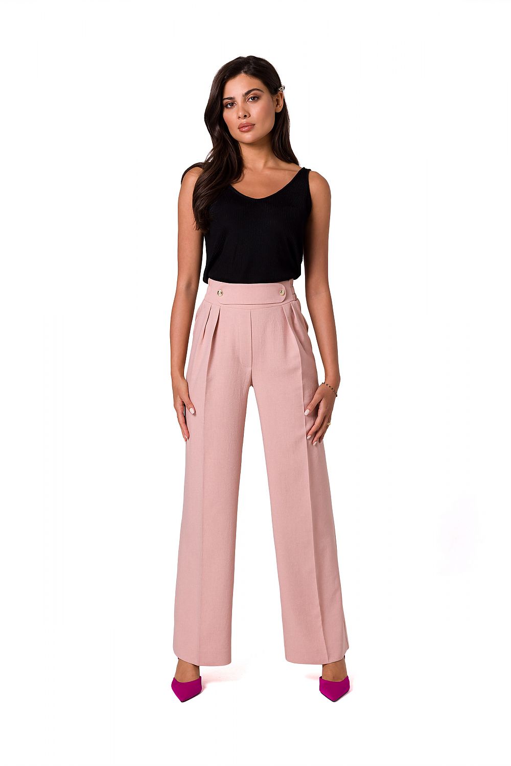 Model in soft pink elegant lightweight trousers with decorative gold buttons by BeWear, paired with a black tank top for a sophisticated appearance.