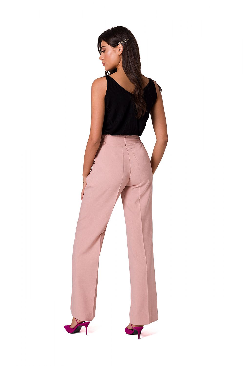 Back view of a model in soft pink elegant lightweight trousers by BeWear, highlighting the stylish design and luxury fabric.