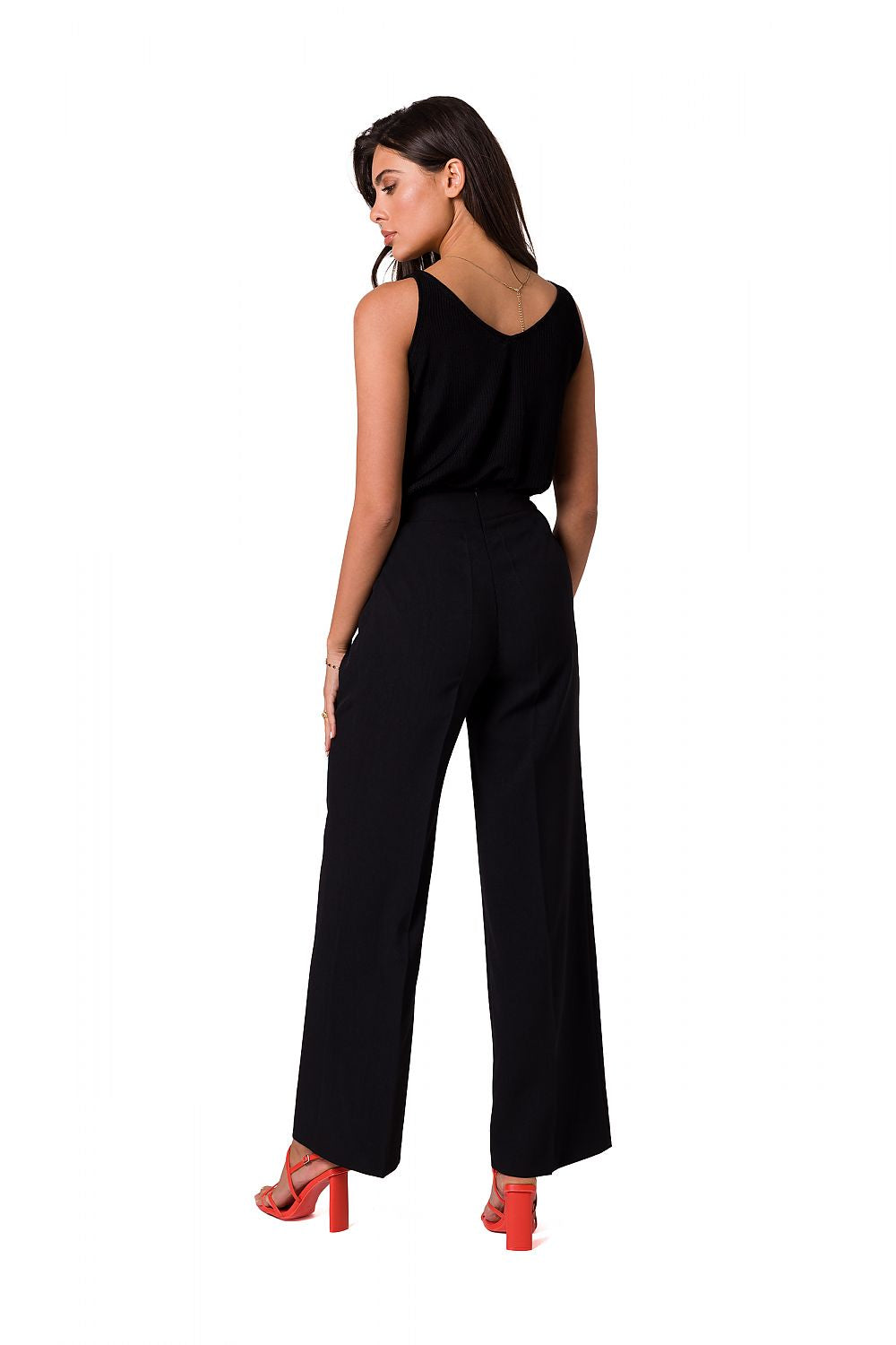 Stylish black wide-leg trousers by BeWear, showcasing decorative gold buttons, model viewed from the back, highlighting a sophisticated ensemble complemented by vibrant red heels.