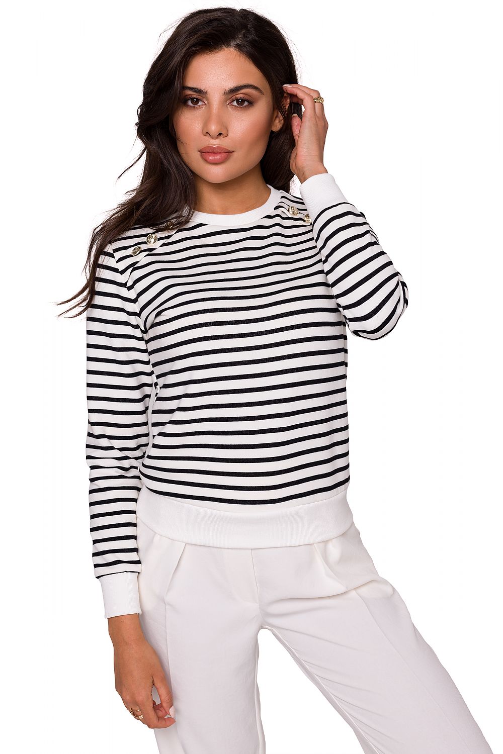 Elegant woman wearing a navy striped cotton knit sweatshirt with gold buttons by BeWear, styled with chic white trousers, showcasing sporty luxury.