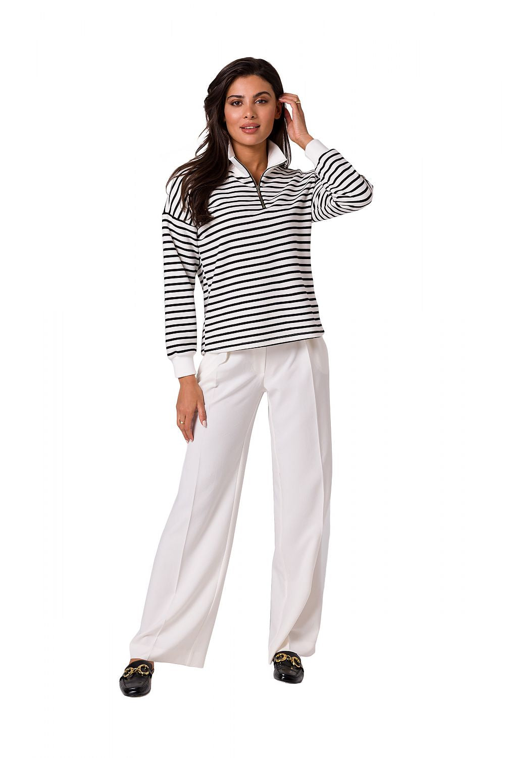 Fashionable model showcasing the BeWear high collar zip sweatshirt paired with white trousers, suitable for chic casual wear in warm weather.