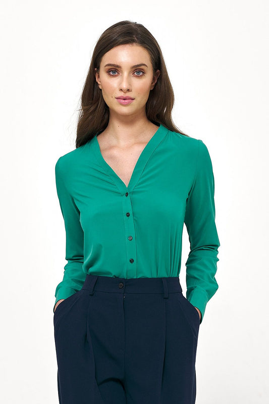 Elegant long sleeve button-down shirt by Nife in vibrant green, perfect for stylish office wear, complemented by chic tailored trousers.