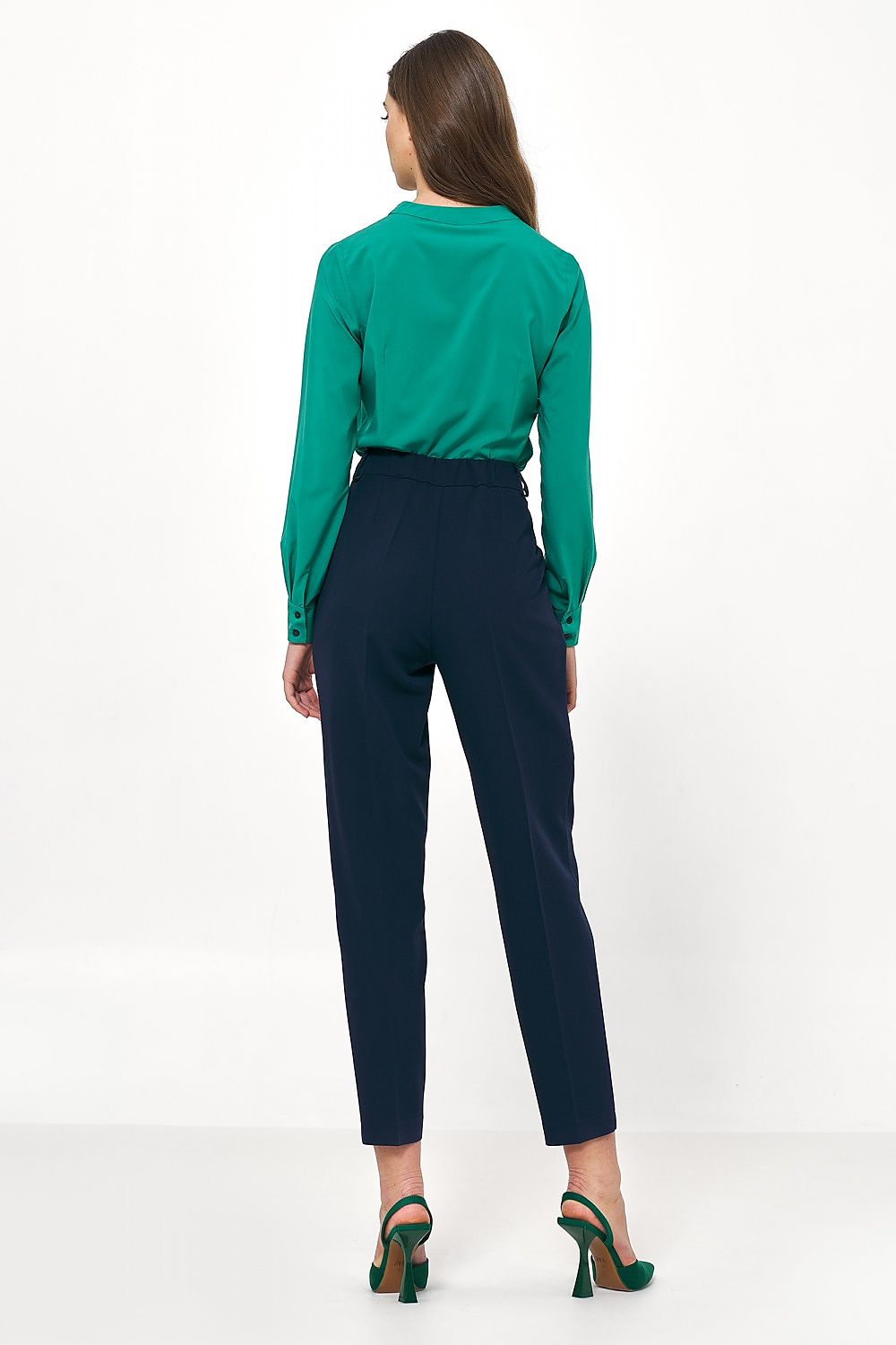 Elegant rear perspective of the Nife button-down shirt styled with navy trousers, emphasising chic sophistication for fashionable office wear.