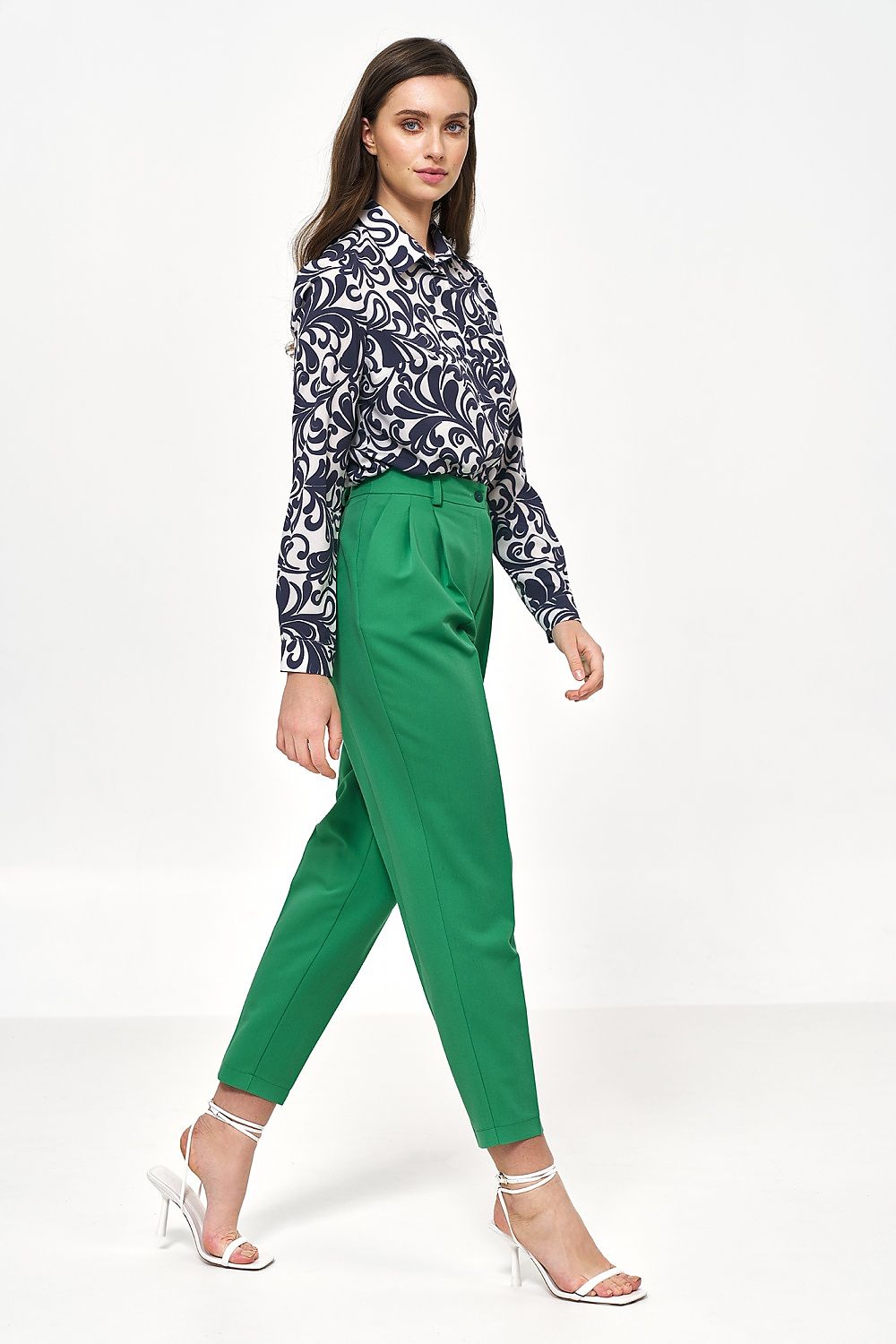 Fashionable side profile of a model wearing green high-waisted balloon pants and a patterned shirt by Nife, embodying a modern luxury style suitable for any occasion.