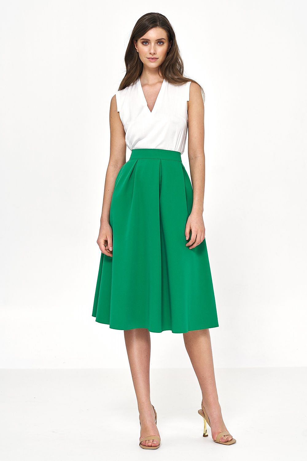 Elegant flared midi skirt by Nife in vibrant green, styled with a white sleeveless top, exuding sophisticated charm and ideal for both office and casual settings.