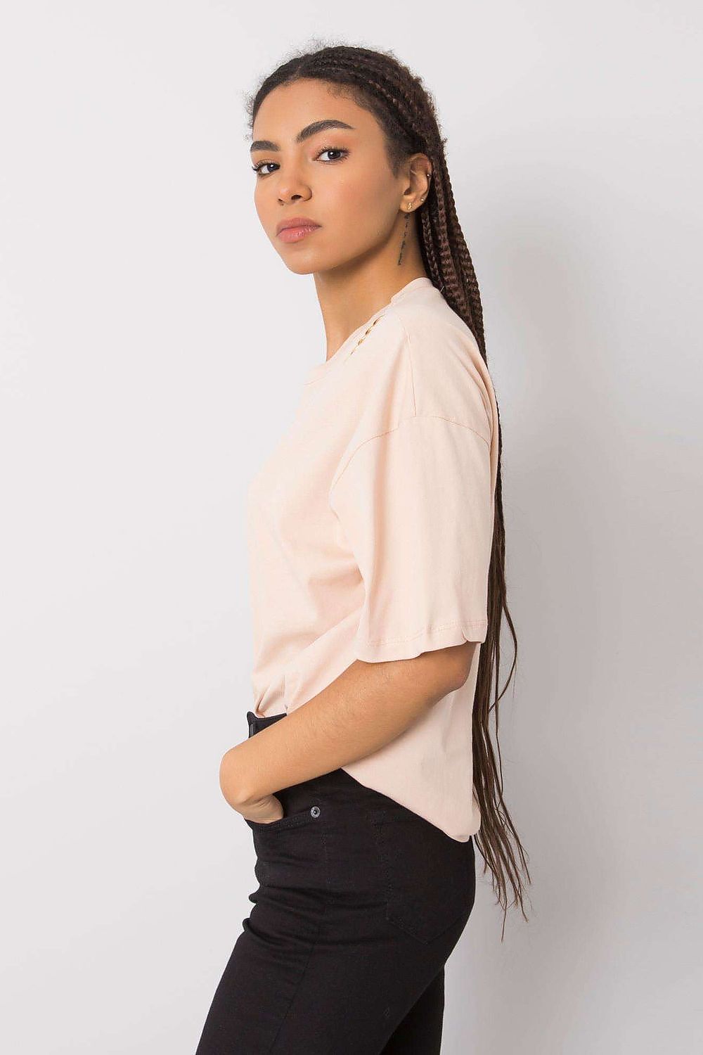 Side view of a stylish women's loose-fit t-shirt by Rue Paris, featuring decorative shoulder details, ideal for casual elegance.