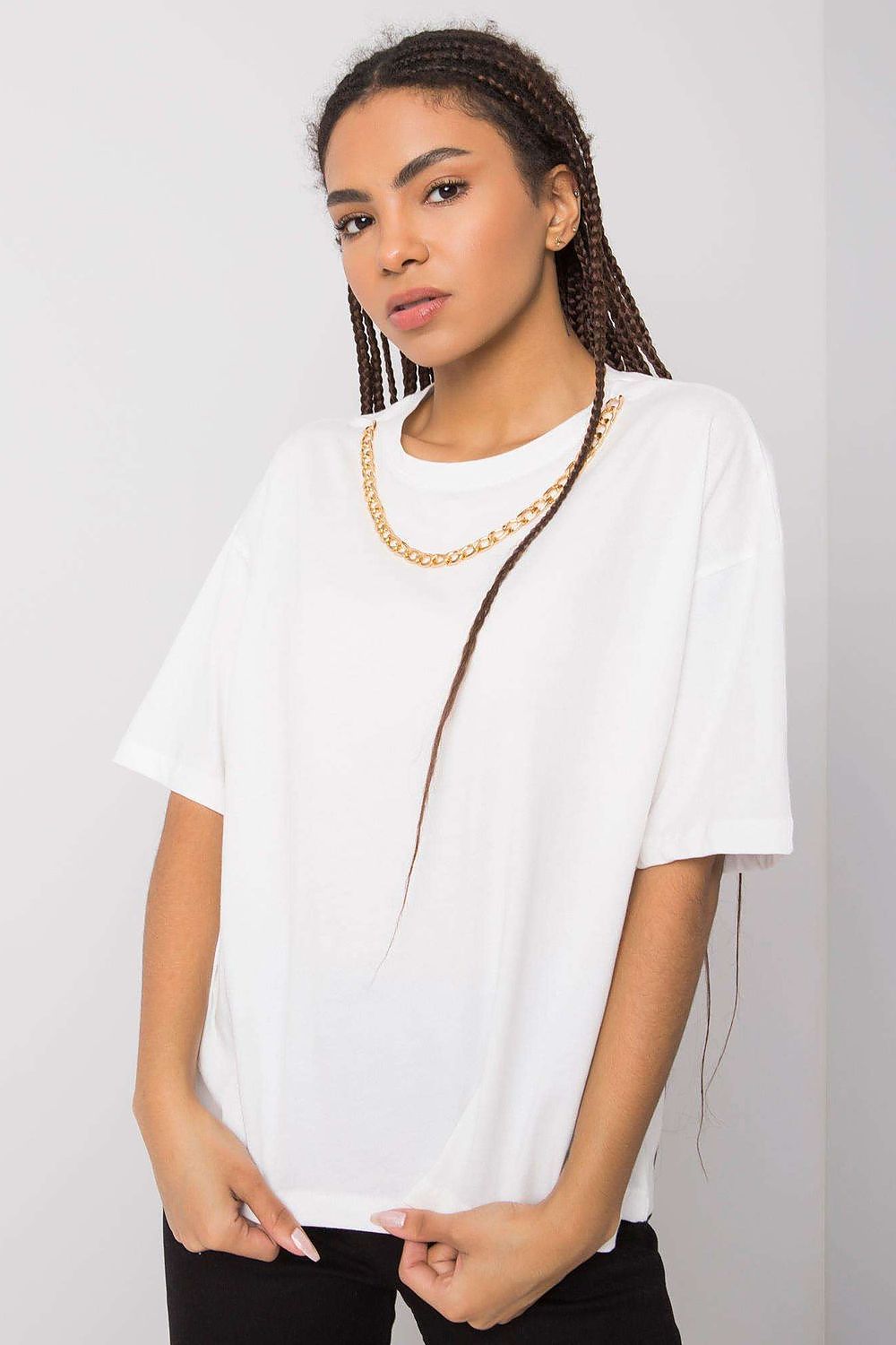 Front view of a chic white loose-fit women's t-shirt by Rue Paris adorned with a decorative chain, epitomising modern luxury.