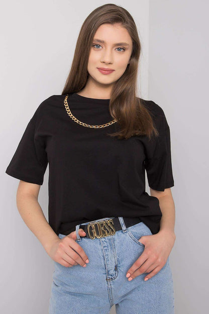Close-up of a fashionable women's black t-shirt by Rue Paris with decorative chain highlight, perfectly styled with high-waisted jeans and a statement belt.