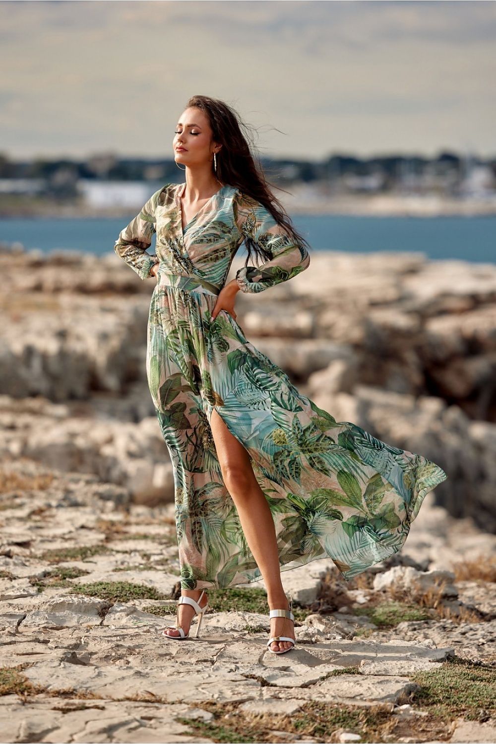 Elegant maxi daydress by Roco Fashion featuring a stylish slit and long sleeves, set against a coastal backdrop, perfect for sophisticated occasions.