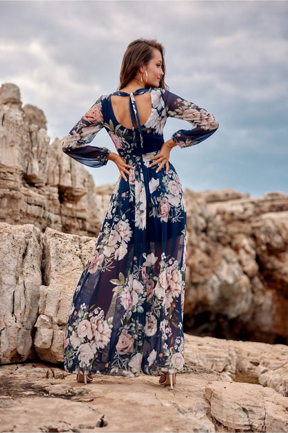 Feminine view of a navy floral maxi dress by Roco Fashion, highlighting a beautifully crafted back design, perfect for weddings and special events.