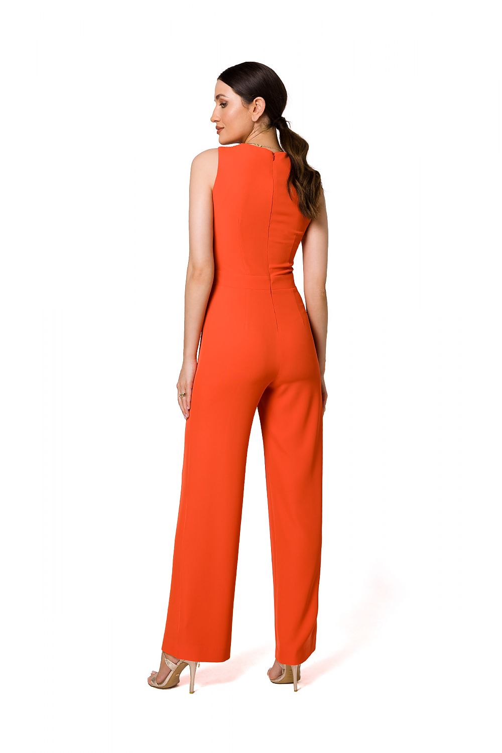 Sophisticated back view of a vibrant orange jumpsuit by Makover, revealing a sleek and tailored design perfect for formal occasions.