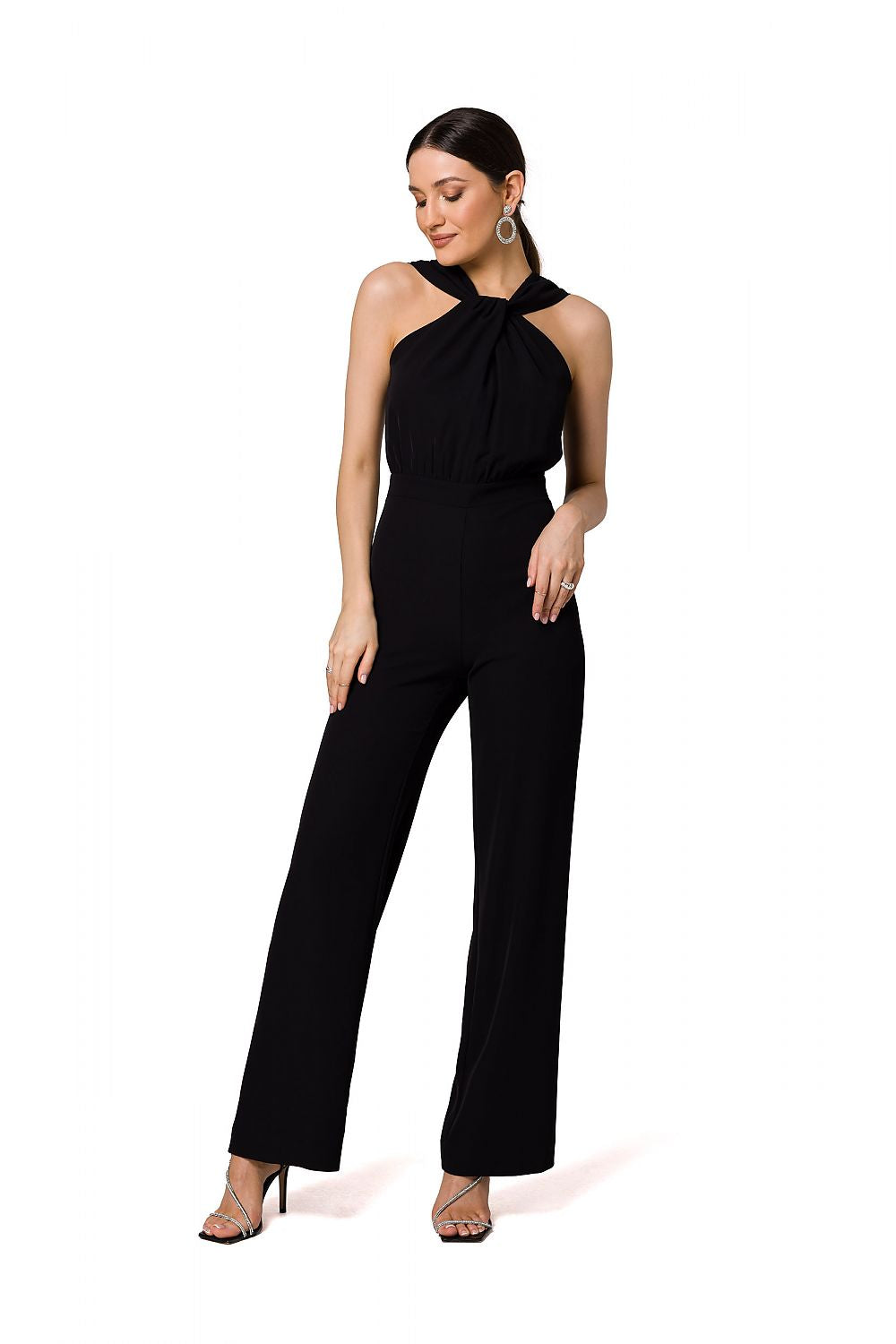 Chic black jumpsuit by Makover, featuring a beautiful halter neck design and flowing wide legs for an elegant evening look.