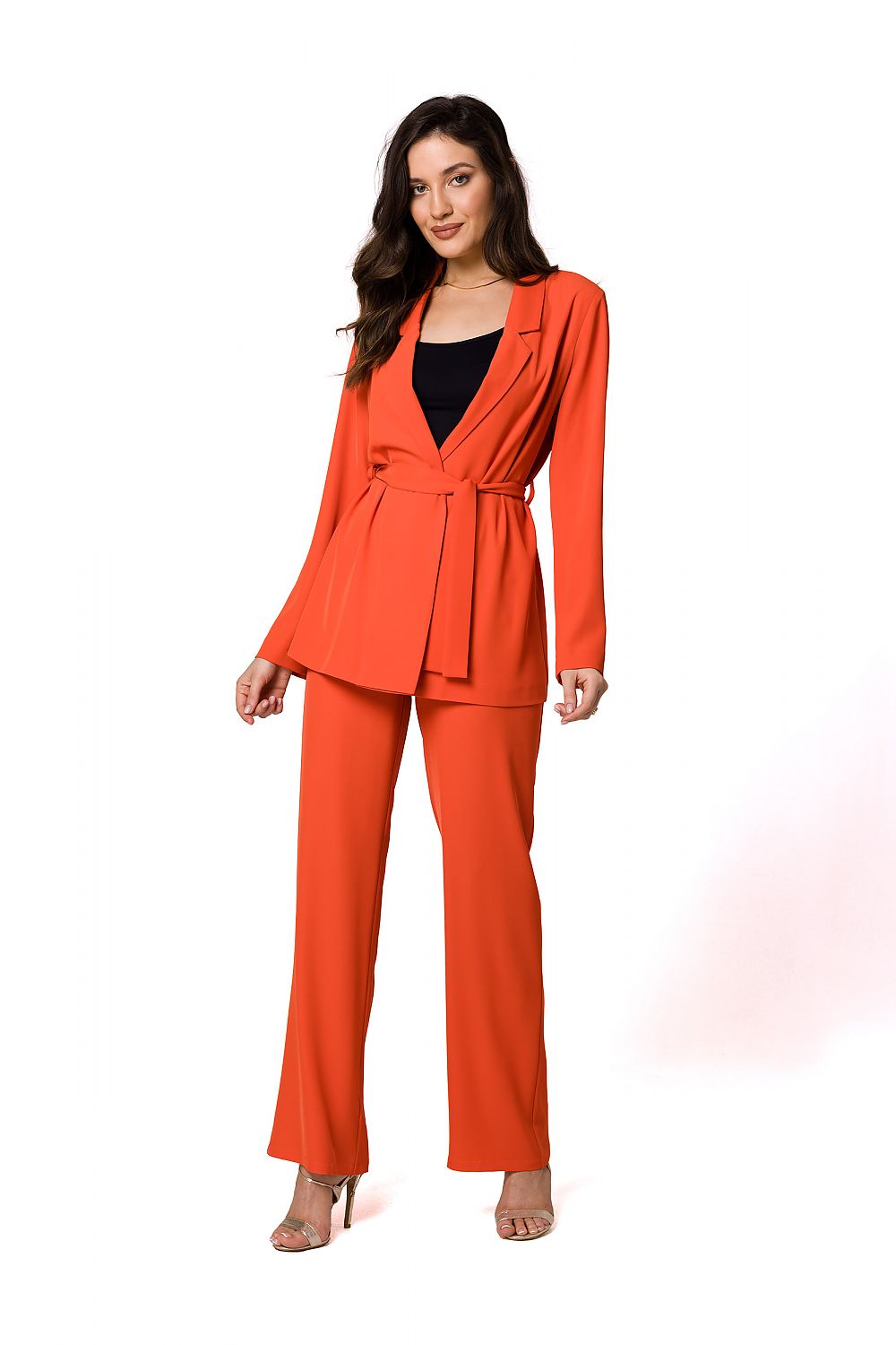 Luxury flowing women's jacket in bold orange, styled with matching trousers, showcasing contemporary femininity by Makover.