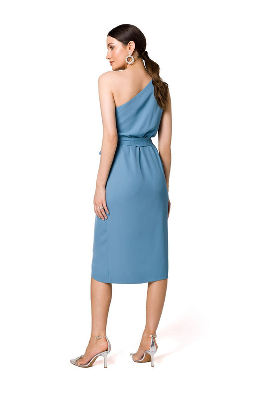 Back view of the exquisite blue one-shoulder cocktail dress by Makover, displaying elegant draping and a chic belt.