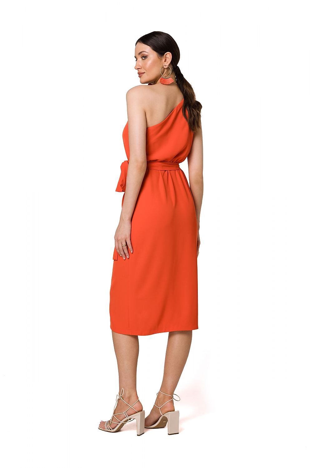 Back view of a sophisticated orange one-shoulder cocktail dress with draping and a belt, crafted by Makover.