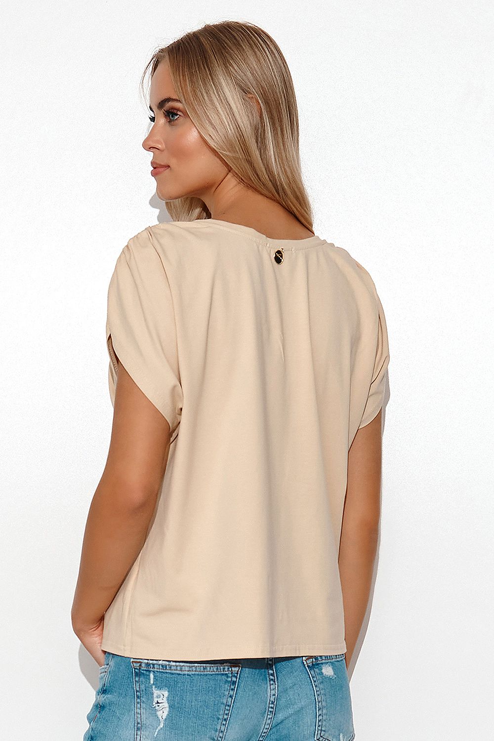 Back view of the elegant Makadamia oversize blouse featuring ribbed cuffs and decorative elements, perfect for a stylish and relaxed women's outfit.
