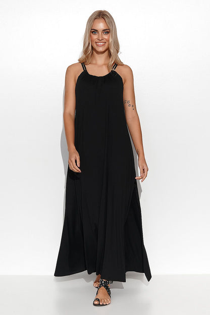 Fashionable model wearing a chic black Makadamia viscose long dress with a side slit, exuding sophistication for evening outings.
