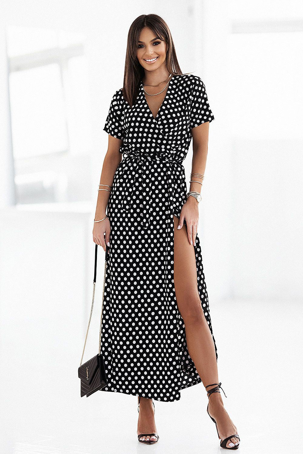 Elegant model wearing an IVON Collection maxi dress showcasing a stylish pea print, featuring a V-neckline and a thigh-high slit, perfect for chic summer outings.