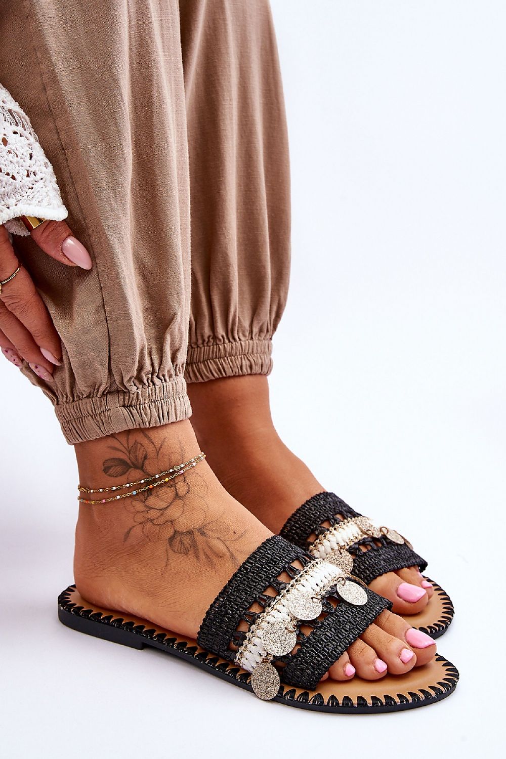 Close-up view of luxurious women's flip-flops featuring decorative elements, designed by Step in Style. The image highlights the intricate details and eco-friendly materials of the footwear.