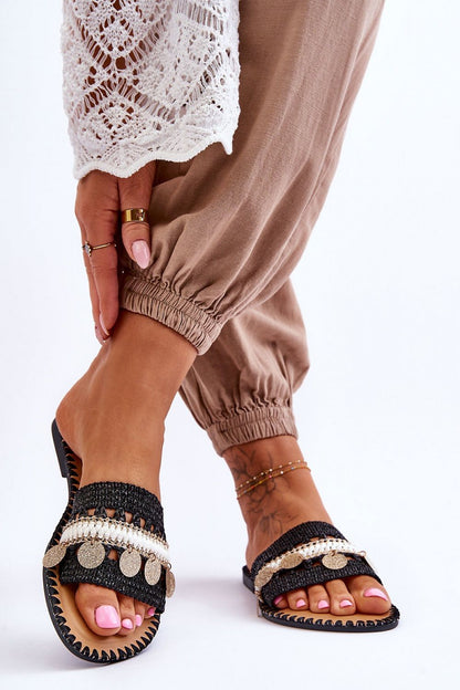 Chic image of women's flip-flops with stylish lurex accents, captured in a fashionable setting by Step in Style. The model's relaxed outfit perfectly enhances the elegance of the footwear.