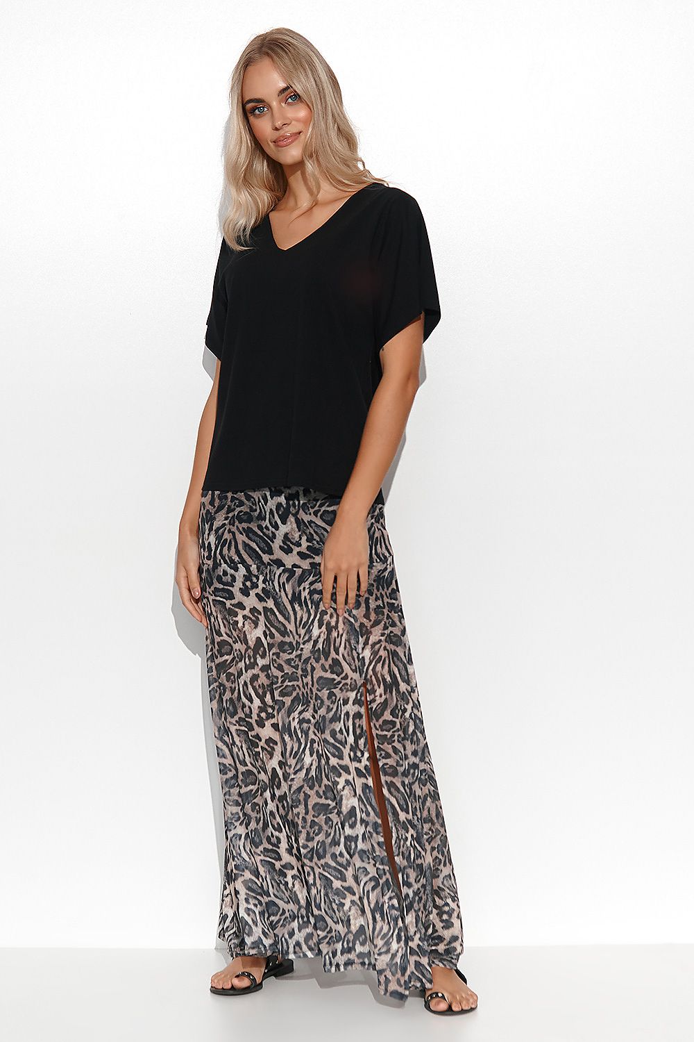 Fashionable V-neck blouse by Makadamia in black, presented with a stylish leopard print skirt, embodying luxurious versatility and contemporary elegance.