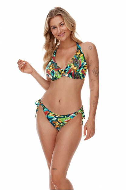 Model showcasing the elegant Lupo Line swimming bra with exotic leaf motif in vibrant colours. The supportive bralette is designed for all bust sizes, ideal for beachwear.