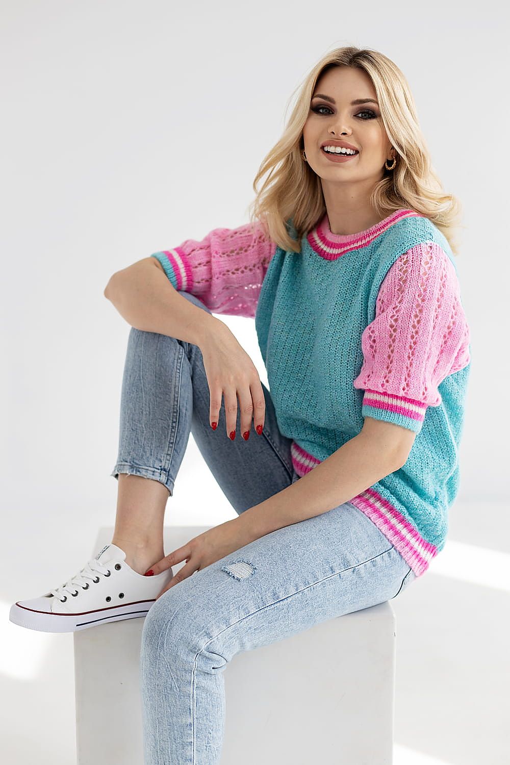 Chic short sleeve sweater from PeeKaBoo, adorns a vibrant pink and teal colour scheme with openwork textures, effortlessly stylish for daytime wear.