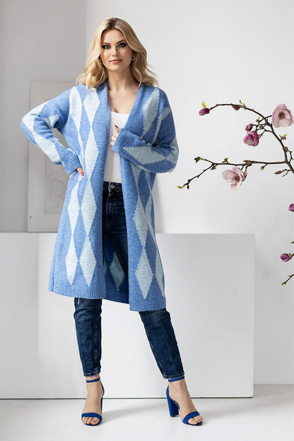PeeKaBoo designer cardigan in blue hues with a geometric pattern, worn over a white top and denim, showcasing a luxurious style.
