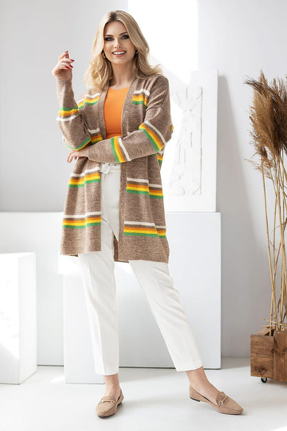 Fashionable PeeKaBoo striped cardigan displayed confidently, with bright green and yellow stripes, styled effortlessly with tailored white trousers and a trendy orange top.