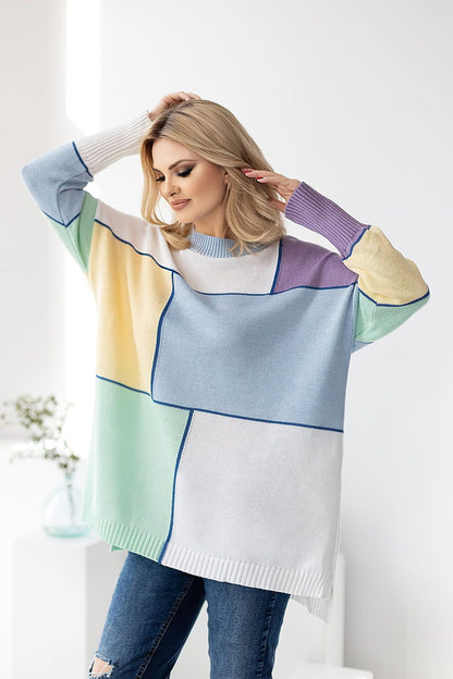 Chic loose-fitting sweater by PeeKaBoo, featuring a sophisticated colour block design. The model showcases long sleeves in soft acrylic and cotton blend, stylishly posing with one hand in her hair against a bright, minimalist backdrop.