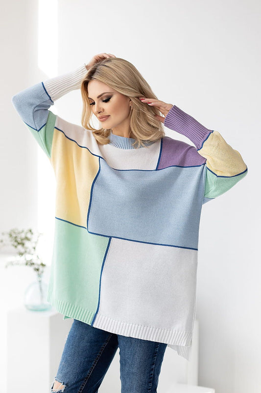 Chic loose-fitting sweater by PeeKaBoo, featuring a sophisticated colour block design. The model showcases long sleeves in soft acrylic and cotton blend, stylishly posing with one hand in her hair against a bright, minimalist backdrop.