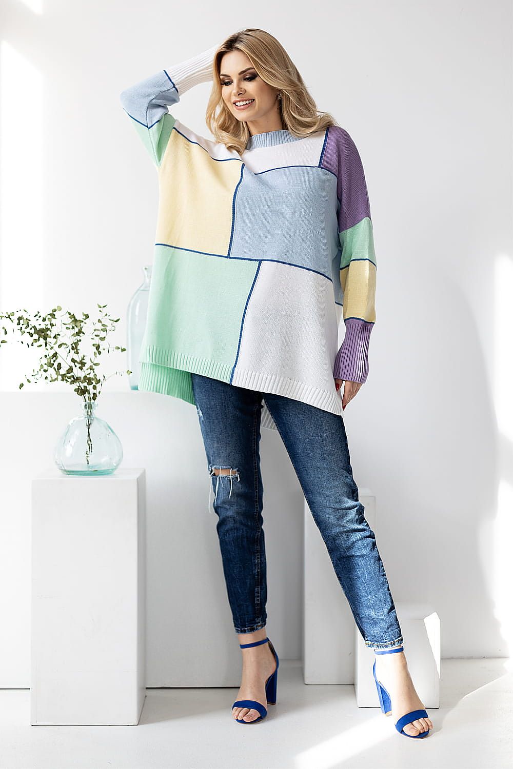 PeeKaBoo Colour Block Loose-Fitting Sweater in pastel hues. Model poses confidently with long sleeves and stylish jeans against a bright background, highlighting the elegance of this acrylic and cotton blend.