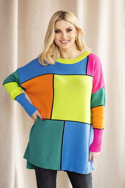 Dazzling model in a vibrant PeeKaBoo Colour Block Loose-Fitting Sweater featuring a dynamic colour palette. The stylish design is perfectly paired with dark trousers, epitomising sophisticated casual fashion.