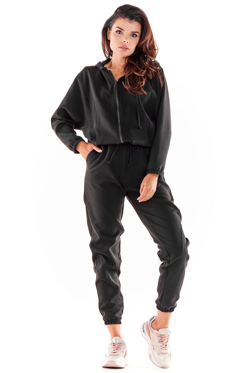 Luxurious Awama tracksuit trousers in black, featuring a loose fit and elastic waistband, styled with sporty details, ideal for casual elegance.