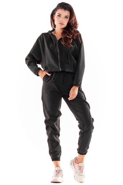 Luxurious Awama tracksuit trousers in black, featuring a loose fit and elastic waistband, styled with sporty details, ideal for casual elegance.
