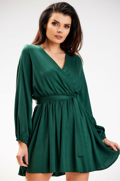 Chic green mini dress with long sleeves and a belt by Awama, effortlessly combining elegance and comfort for any occasion.