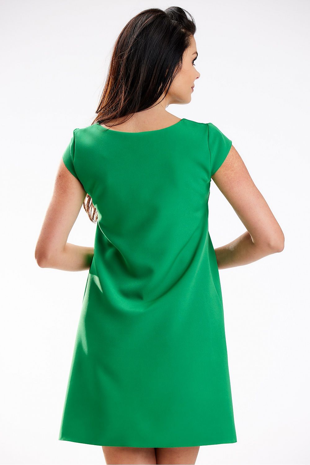 Back view of a sophisticated green mini dress with short sleeves and a trapezoidal cut, designed by awama for enhanced comfort and elegance.